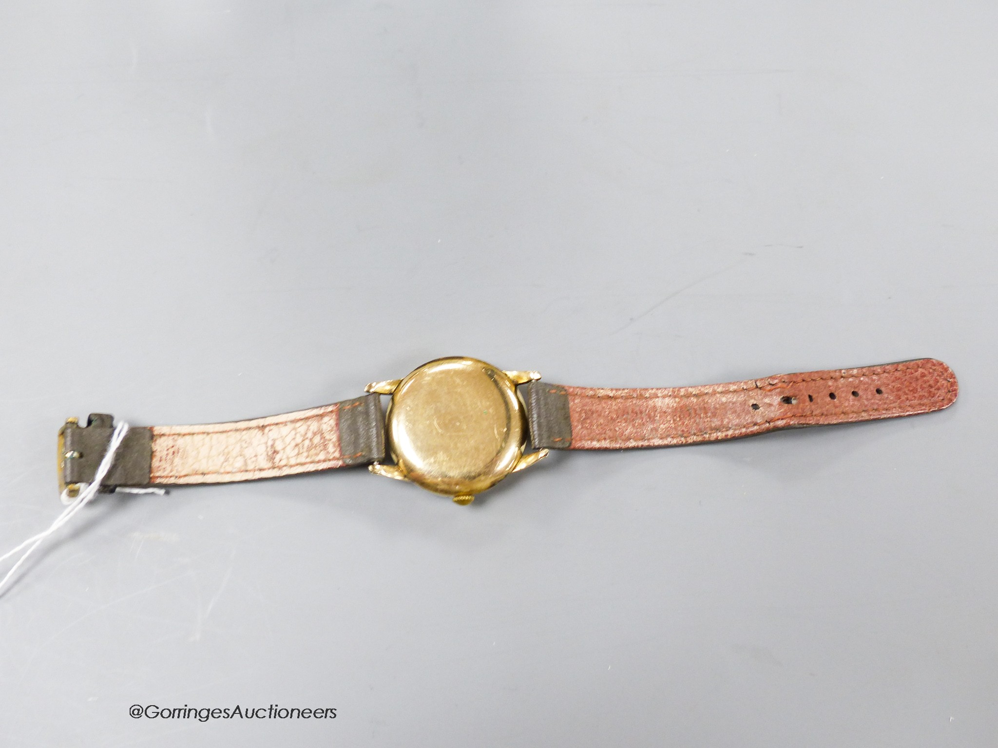 A gentleman's early 1950's gold plated Omega manual wind wrist watch, movement c.283, on associated strap.